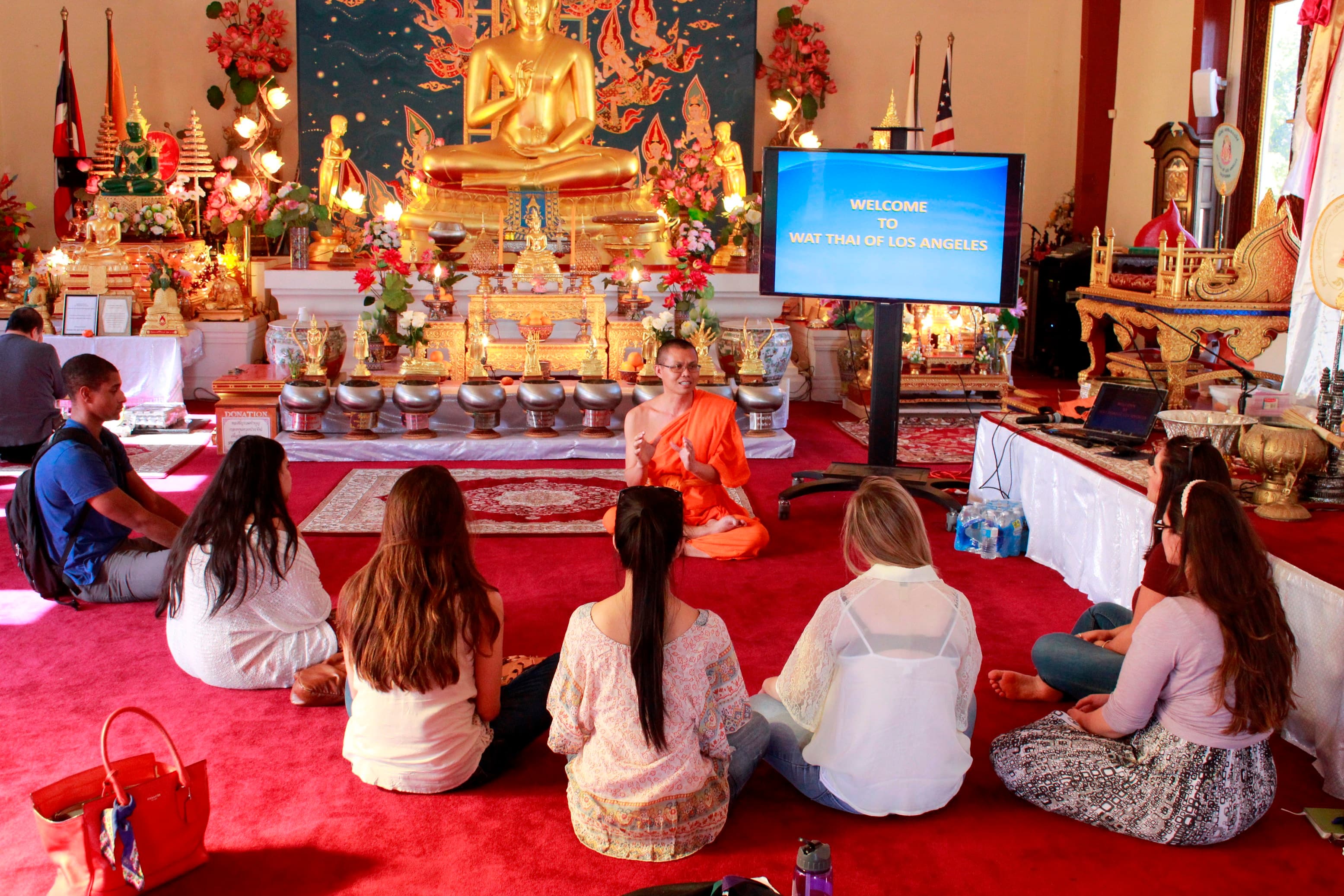 Students visiting Wat Thai for a school project interview