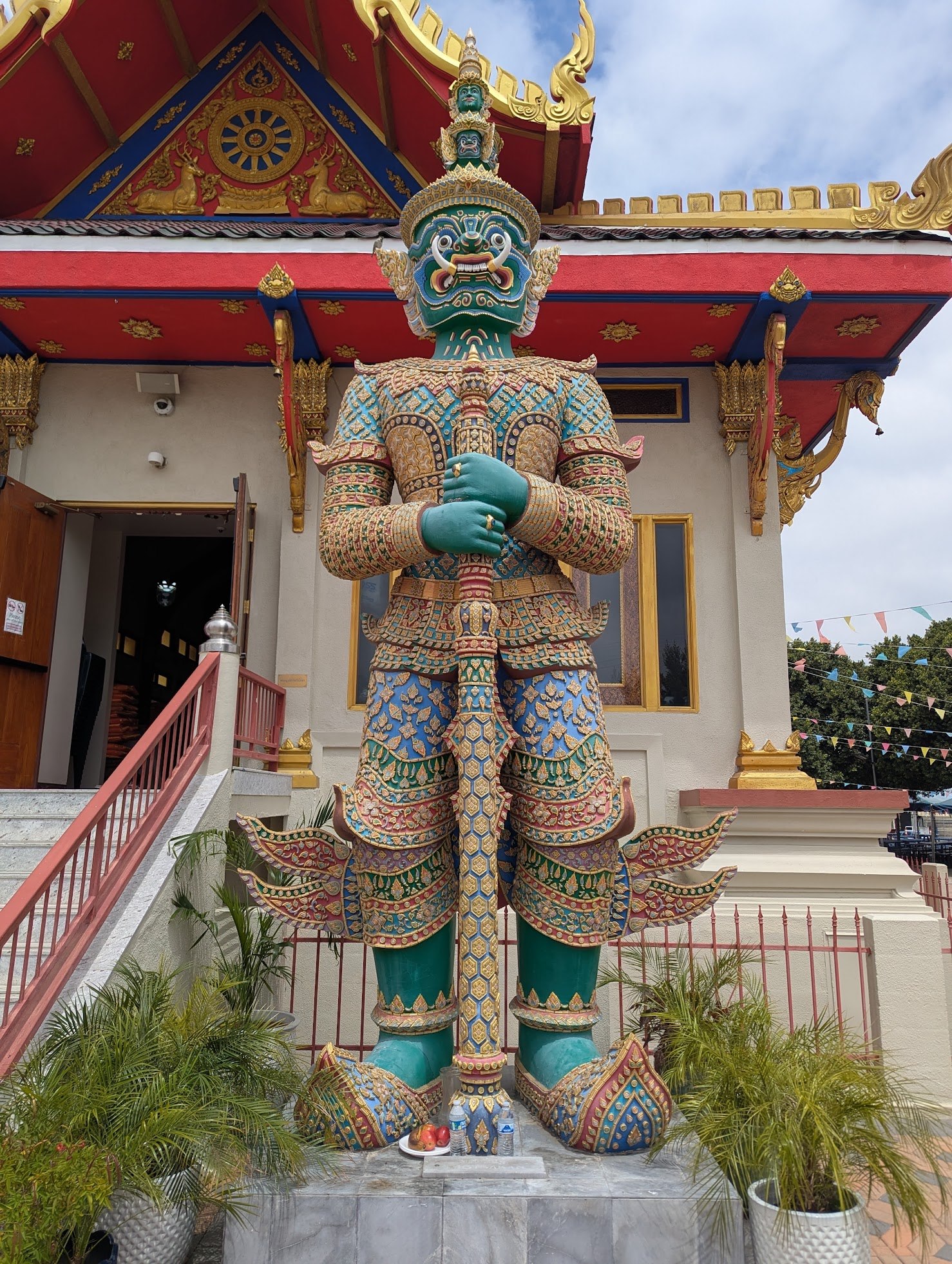 The green Thotsakan guardian statue at the entrance of Wat Thai of Los Angeles